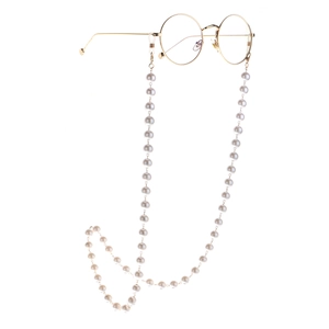 Golden round frame glasses with a long white pearl chain, elegant and vintage style