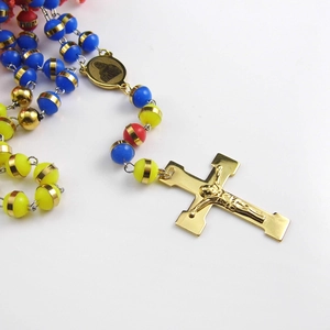 Detailed view of religious rosary beads featuring colorful beads and gold crucifix