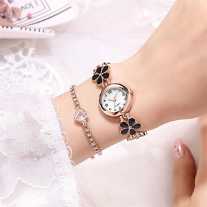 Elegant rose gold watch with black floral strap and matching heart diamond bracelet