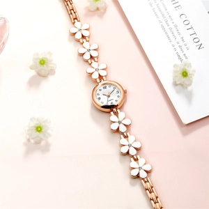 Elegant rose gold quartz watch featuring white daisy floral bracelet links and crystal dial