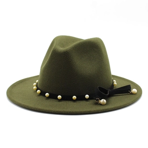Detail of olive green wool fedora hat featuring black ribbon with pearls and bow detail