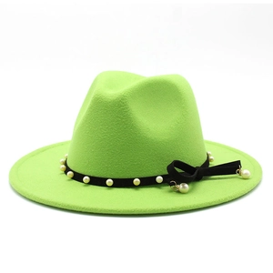 Detail of green wool jazz hat featuring black velvet band with pearls and tassel bow