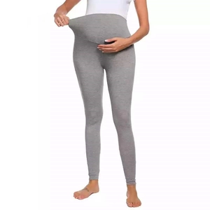 Detail showing the high elastic waistband of heather grey maternity yoga pants for pregnancy