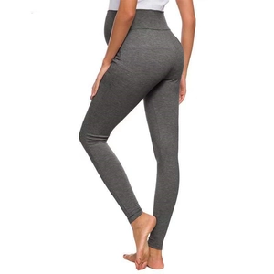 Detail of high-waisted dark grey maternity yoga leggings with supportive belly band