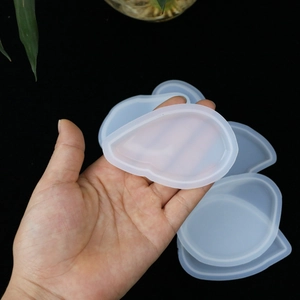 Handheld view of flexible translucent teardrop silicone molds for resin casting crafts