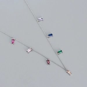 Macro shot of silver necklace featuring colorful rectangular zircon stones and sleek chain