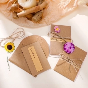 Handmade kraft paper greeting card with dried flowers and twine for special occasions
