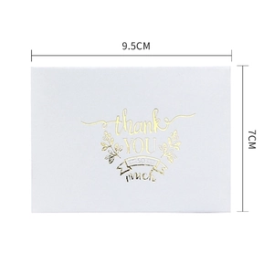 White gold-stamped Thank You greeting card with leaf design and white envelope