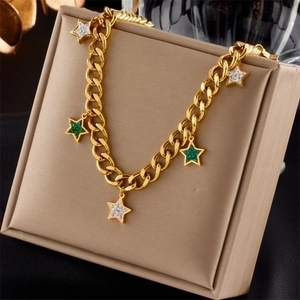 Vintage gold star pendant necklace with turquoise stones on a beige display cushion