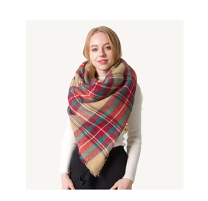 Close-up detail of oversized colorful plaid scarf with soft fringe and cashmere-like texture