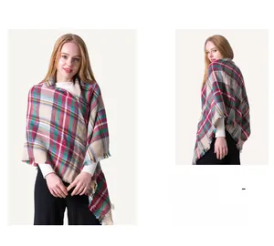 Close-up of classic red and green plaid cashmere-feel shawl with fringe edge detailing