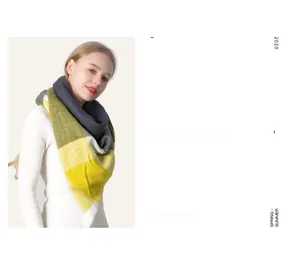 Detail of grey and mustard yellow checkered cashmere-feel scarf on a fashion model