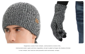Close-up of knit texture on grey marl winter beanie hat and matching knit gloves set