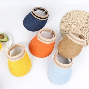 Kids straw sun visors in five vibrant colors arranged on a white vacation style background
