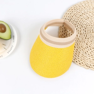 Detail of yellow straw sun visor with striped elastic band on a white background