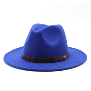 Detailed close-up of blue wool fedora featuring a textured brown leather band and metal pin