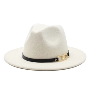 Detail of off-white wool fedora hat featuring black leather band and gold chain accents