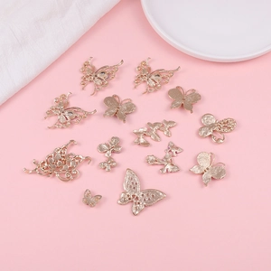 Golden butterfly alloy charms with intricate filigree designs for DIY jewelry and hair accessories