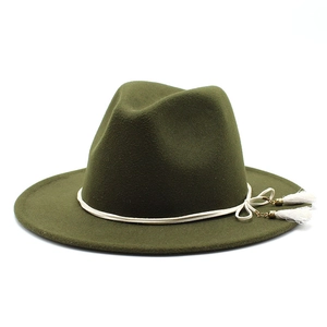 Detail of olive green wool fedora hat featuring white decorative rope and side tassels