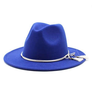 Detail of royal blue wool fedora with white braided rope and fringe tassels
