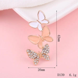 Detailed view of three tiered alloy butterfly charms with enamel and rhinestones for DIY