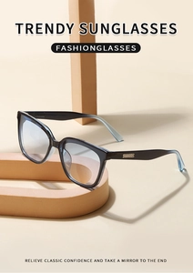 Detail view of black square sunglasses with blue gradient lenses and golden temple stripes