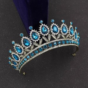 Detailed side view of baroque bridal crown with blue teardrop crystals on bronze metal