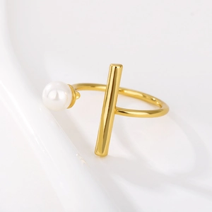 Detail of adjustable 18k gold plated ring with white pearl and geometric bar accent