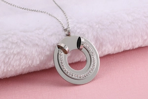 Close-up of a silver hollow circle necklace pendant set with sparkling rhinestones