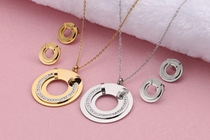 Detailed view of gold and silver jewelry sets with sparkling rhinestones on pink paper