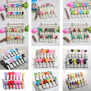 Detail showing various wooden mini clips with cute animals, hearts and stars for photo walls