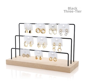 Three-tier black metal earring display stand with natural solid wood base for jewelry