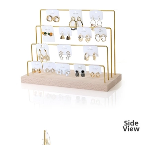 Macro detail of a 4-tier gold metal earring stand with a solid wooden base display