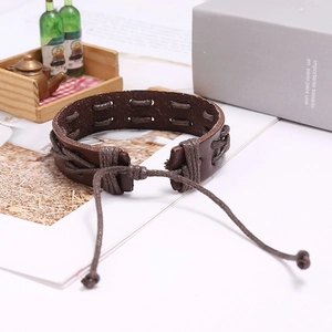 Close-up of vintage brown braided leather bracelet with adjustable cord closure details