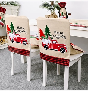 Close-up of beige linen Christmas chair covers featuring red truck and gnome patterns