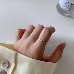 Minimalist gold 925 sterling silver stacked rings set shown on hand with elegant aesthetic
