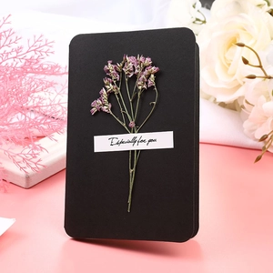Detail of black greeting card with dried pink flowers and Especially for you text