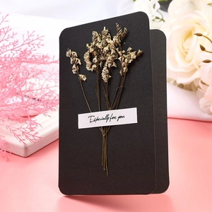 Close-up of handmade black greeting card with dried flowers and Especially for you text