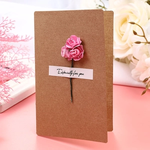 Close-up of handmade pink paper roses on a kraft greeting card with 'Especially for you' tag