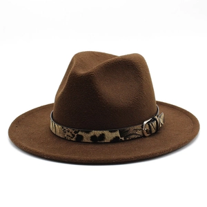 Detailed close-up of brown wool felt fedora with leopard print band and metal buckle
