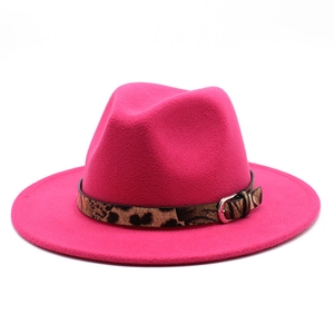 Detail of rose red fedora hat with leopard print band and metal buckle attachment