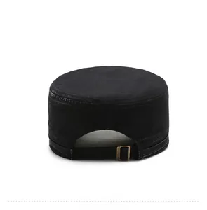 Close-up of the metal adjustable buckle and cotton canvas texture on the black cadet cap
