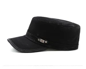 Detail of vintage black military cap featuring distressed denim texture and metal logo