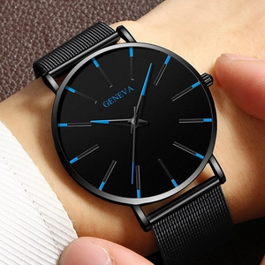 Close-up of minimalist black Geneva watch with blue indices and Milanese mesh strap