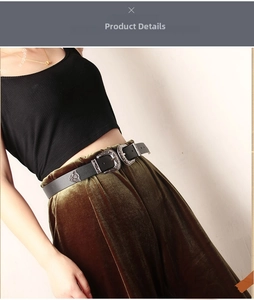 Detail of vintage black belt with double engraved silver buckles on olive velvet skirt