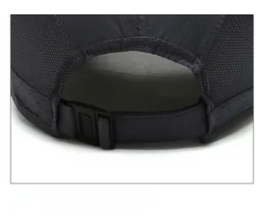 Detail view of the breathable mesh fabric and adjustable plastic buckle on the dark gray cap