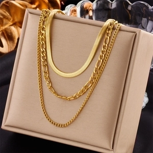 Elegant multi-layered gold titanium steel chain necklace set on a beige display stand