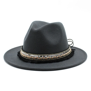 Detail of dark grey fedora hat with sequined band, colorful rope and bohemian fringe