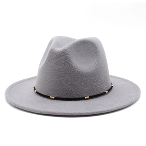 Close-up of wool felt fedora featuring a grey flat brim and black band with gold metal trim