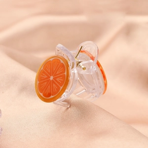 Close-up of cute transparent orange slice hair claw clip for girls and babies